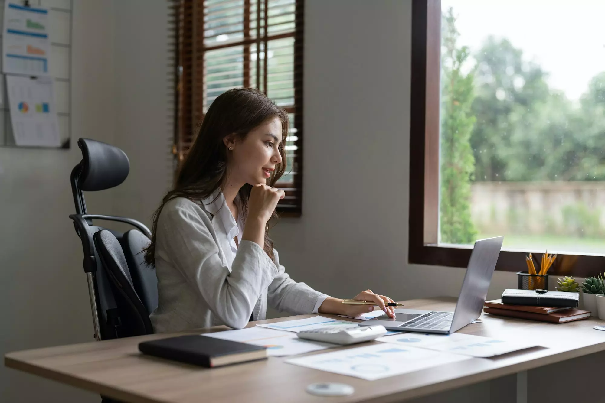 Business owner reviewing automated reports on a computer